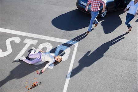 people lying down on the road - Driver rushing to injured girl on street Stock Photo - Premium Royalty-Free, Code: 6113-07761933