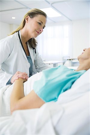 doctor patient compassion - Doctor talking to patient in hospital room Stock Photo - Premium Royalty-Free, Code: 6113-07761936