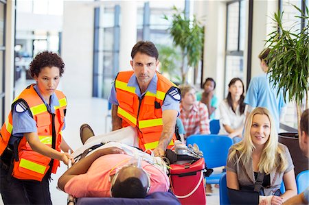 Paramedics wheeling patient in hospital Photographie de stock - Premium Libres de Droits, Code: 6113-07762042