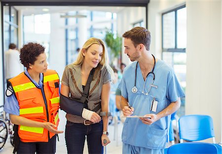 Nurse and paramedic talking to patient in hospital Stock Photo - Premium Royalty-Free, Code: 6113-07762052