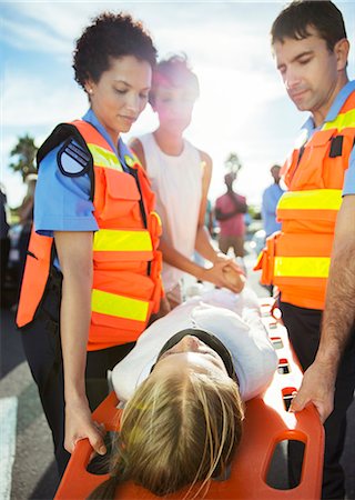 simsearch:6113-08105486,k - Paramedics carrying patient on stretcher Stock Photo - Premium Royalty-Free, Code: 6113-07762066