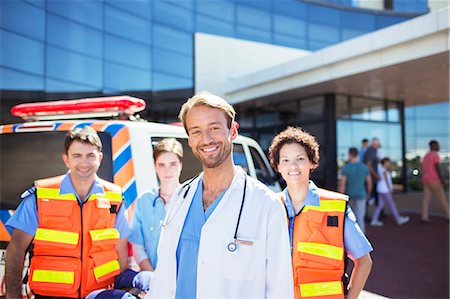 first responder - Doctor smiling with paramedics in hospital parking lot Stock Photo - Premium Royalty-Free, Code: 6113-07762014