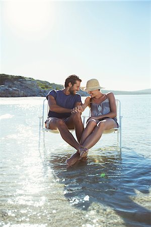 simsearch:6113-07762186,k - Couple sitting in chairs in waves Stockbilder - Premium RF Lizenzfrei, Bildnummer: 6113-07762118