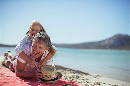 Grandfather and granddaughter playing on beach Stock Photo - Premium Royalty-Free, Code: 6113-07762134