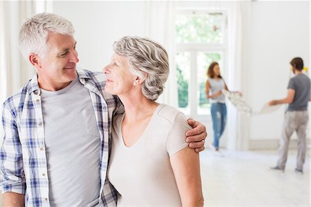 Older couple smiling together in living space Stock Photo - Premium Royalty-Free, Code: 6113-07762251