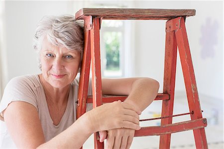 retiree - Older woman leaning on ladder in living space Stock Photo - Premium Royalty-Free, Code: 6113-07762284