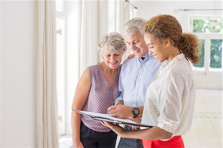 sold house - Older couple and woman signing documents Stock Photo - Premium Royalty-Free, Code: 6113-07762229