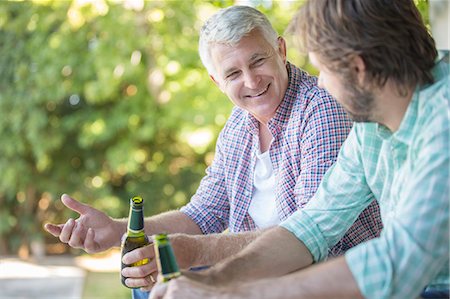 Father and son drinking outdoors Stock Photo - Premium Royalty-Free, Code: 6113-07762236