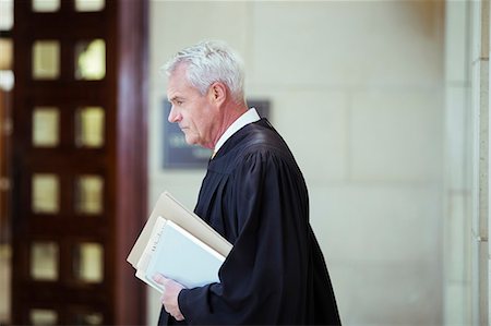 Judge walking through courthouse Stock Photo - Premium Royalty-Free, Code: 6113-07762340