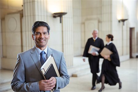 simsearch:6113-07762466,k - Lawyer holding legal documents in courthouse Stock Photo - Premium Royalty-Free, Code: 6113-07762379