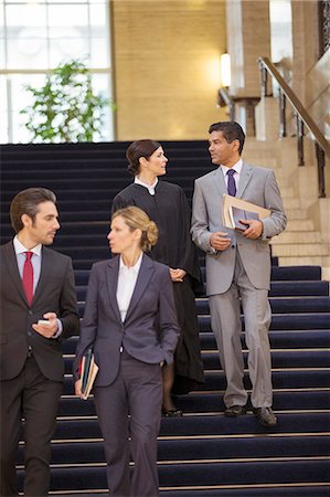 Judge and lawyers talking and walking through courthouse Stock Photo - Premium Royalty-Free, Code: 6113-07762380