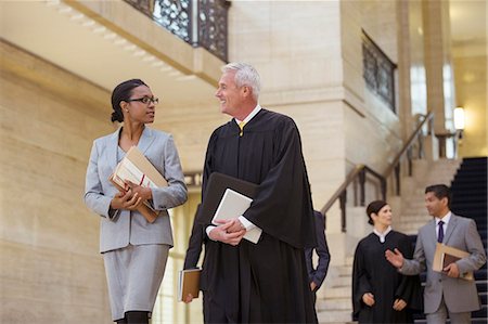 simsearch:6113-07762453,k - Judge and lawyer walking through courthouse together Stock Photo - Premium Royalty-Free, Code: 6113-07762381