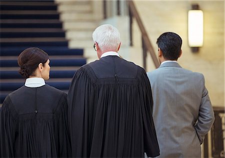 simsearch:6113-07762466,k - Judges and lawyer walking through courthouse together Stock Photo - Premium Royalty-Free, Code: 6113-07762382