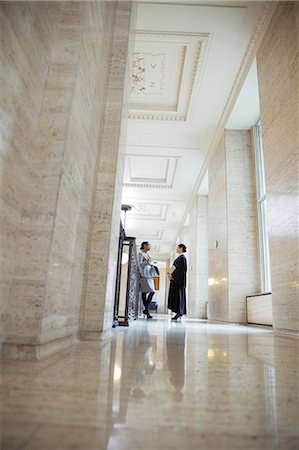 female judges in robes - Judge and lawyer talking in courthouse Stock Photo - Premium Royalty-Free, Code: 6113-07762386