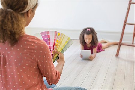 Woman looking through color swatches Stock Photo - Premium Royalty-Free, Code: 6113-07762300