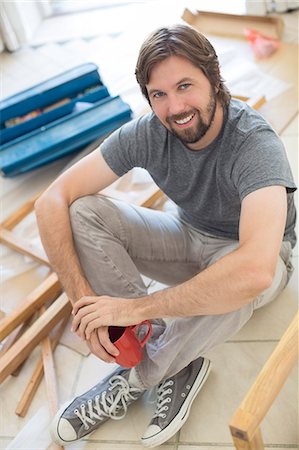 renovation - Man sitting on ground holding cup of coffee Stock Photo - Premium Royalty-Free, Code: 6113-07762313