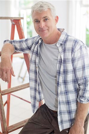 Older man leaning on ladder Stock Photo - Premium Royalty-Free, Code: 6113-07762315