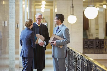 Judge and lawyers talking in courthouse Stock Photo - Premium Royalty-Free, Code: 6113-07762455