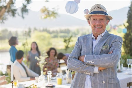 family gathering laughing - Older man enjoying picnic with family Stock Photo - Premium Royalty-Free, Code: 6113-07762477