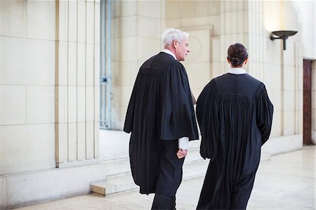 Judges walking through courthouse together Stock Photo - Premium Royalty-Free, Code: 6113-07762404