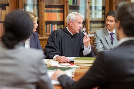 simsearch:6113-07762466,k - Judge and lawyers talking in chambers Stock Photo - Premium Royalty-Free, Code: 6113-07762413