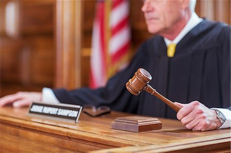 Judge banging gavel in court Stock Photo - Premium Royalty-Free, Code: 6113-07762429