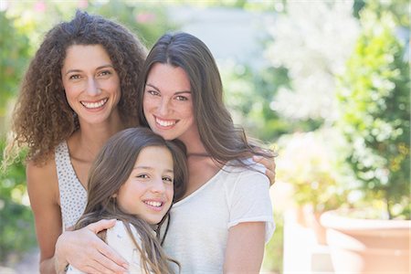 Sisters hugging outdoors Fotografie stock - Premium Royalty-Free, Codice: 6113-07762576