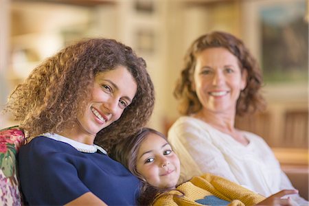 Three generations of women relaxing on couch together Stock Photo - Premium Royalty-Free, Code: 6113-07762581