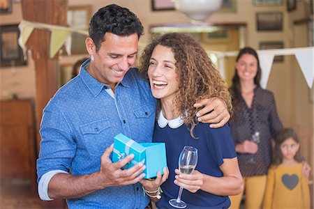 family gathering - Couple opening gift together Stock Photo - Premium Royalty-Free, Code: 6113-07762597