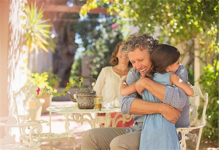 simsearch:6113-07762491,k - Grandfather and granddaughter hugging outdoors Stock Photo - Premium Royalty-Free, Code: 6113-07762594