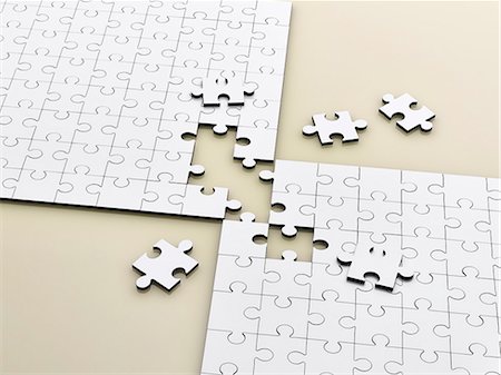puzzle - Close up of connecting puzzle with scattered pieces Stock Photo - Premium Royalty-Free, Code: 6113-07790181
