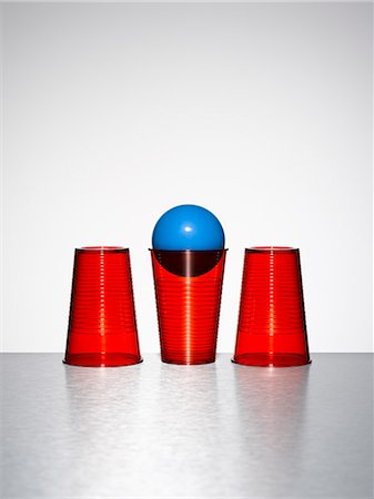 simsearch:6113-08088263,k - Blue ball in middle of three red cups Stock Photo - Premium Royalty-Free, Code: 6113-07790186