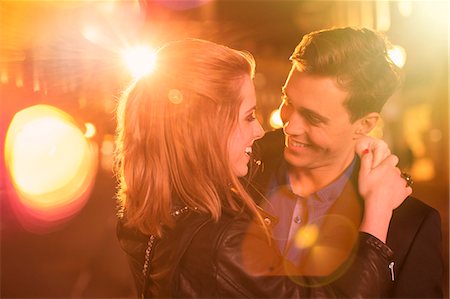 people in the city at night - Couple hugging on city street at night Stock Photo - Premium Royalty-Free, Code: 6113-07790275