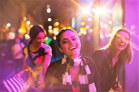 smiling laughing portrait city - Friends playing on city street at night Stock Photo - Premium Royalty-Free, Code: 6113-07790279