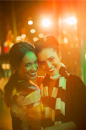 simsearch:6113-07790257,k - Women smiling together on city street at night Stockbilder - Premium RF Lizenzfrei, Bildnummer: 6113-07790289