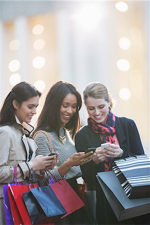 shopping on a mobile device - Women using cell phones on city street Stock Photo - Premium Royalty-Free, Code: 6113-07790222