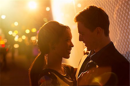 Couple hugging on city street at night Stock Photo - Premium Royalty-Free, Code: 6113-07790237