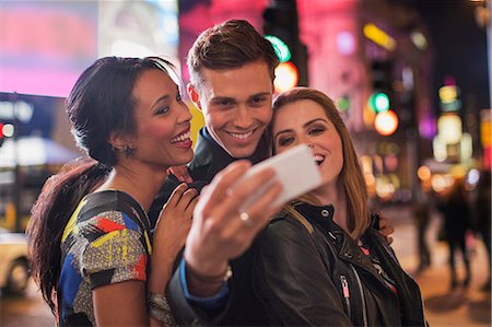 selfie night out - Friends taking picture together with cell phone Stock Photo - Premium Royalty-Free, Code: 6113-07790236