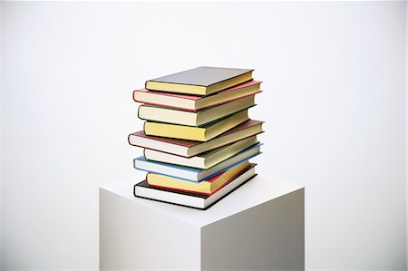 photograph of still life - Stack of books on pedestal Stock Photo - Premium Royalty-Free, Code: 6113-07790384