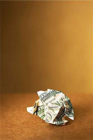 Close up of crumpled dollar bill on counter Stock Photo - Premium Royalty-Free, Code: 6113-07790403