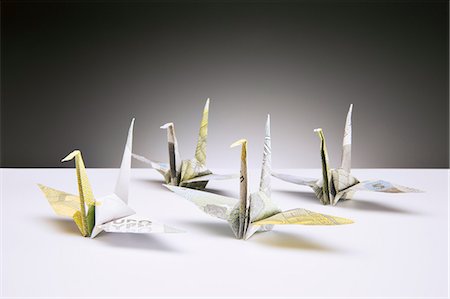 Origami cranes made of Euros on counter Stock Photo - Premium Royalty-Free, Code: 6113-07790412