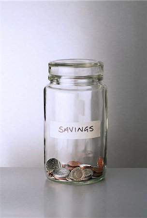 simsearch:400-07215779,k - Savings change jar on counter Photographie de stock - Premium Libres de Droits, Code: 6113-07790421