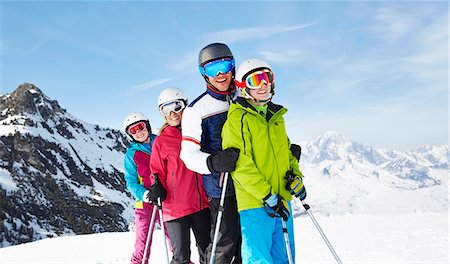 family skiing - Family skiing on mountain top Stock Photo - Premium Royalty-Free, Code: 6113-07790592