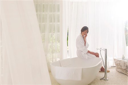relax recharge unwind - Woman running bath in modern bathroom Stock Photo - Premium Royalty-Free, Code: 6113-07790501