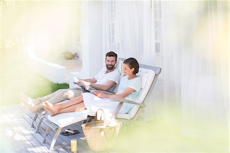 sitting on terrace - Couple relaxing together in lawn chairs outdoors Stock Photo - Premium Royalty-Free, Code: 6113-07790518