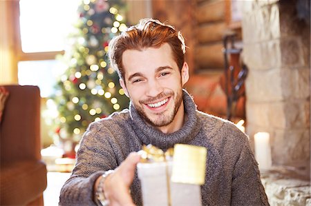 simsearch:614-06624568,k - Man offering gifts on Christmas Stock Photo - Premium Royalty-Free, Code: 6113-07790602