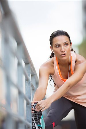 simsearch:6113-07790771,k - Woman stretching her legs before exercise Stock Photo - Premium Royalty-Free, Code: 6113-07790747