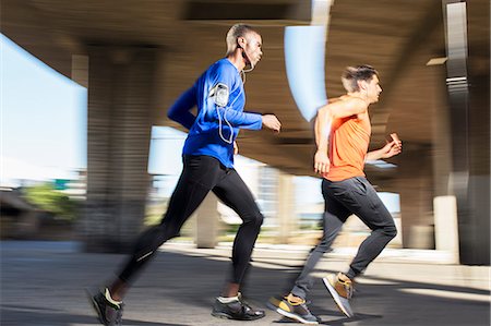 simsearch:6113-07790755,k - Men running through city streets together Stock Photo - Premium Royalty-Free, Code: 6113-07790755