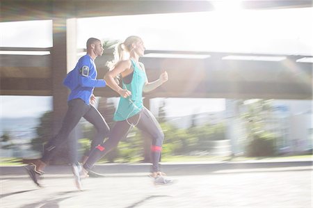 person jogging in city - Couple running through city streets together Stock Photo - Premium Royalty-Free, Code: 6113-07790765