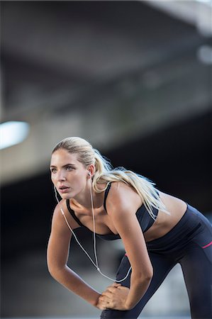 fitness and exercise with blonde woman - Woman stretching before exercising on city street Stock Photo - Premium Royalty-Free, Code: 6113-07790783